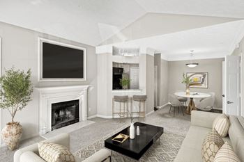 A living room with a fireplace and a television on the wall.