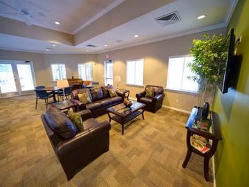 Jacksonville apartment for rent - A living room with brown leather couches and a carpeted floor.