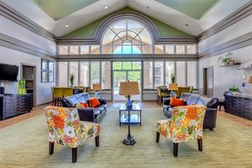 Jacksonville apartment for rent - A living room with a large window and a sofa set.