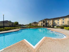 Naples apartment for rent - Resort Style Swimming Pool with Building Exterior in the Background