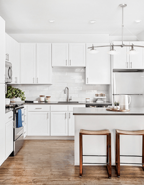 Denver apartment for rent - A kitchen with white cabinets and a white counter top.