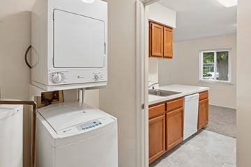 Waldorf apartment for rent - A white dishwasher is in a kitchen with wooden cabinets.