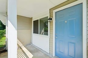 Waldorf apartment for rent - A blue door is on the right side of a house.