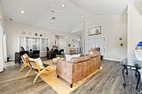 Tallahassee apartment for rent - A living room with a couch, chairs, and a coffee table.
