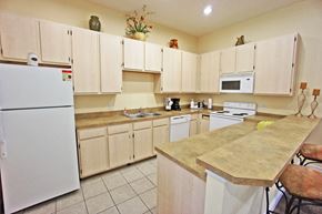 Kissimmee apartment for rent - a kitchen with white cabinets and white appliances