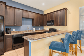Jacksonville apartment for rent - a kitchen with a bar and a counter top with chairs