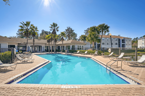 Jacksonville apartment for rent - our apartments have a swimming pool with chairs and palm trees