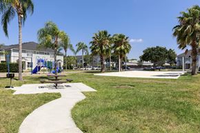Vero Beach apartment for rent - Sidewalk to Picnic Table with Bench Next to Park Style Grill Between Playground and Sand Volleyball Court
