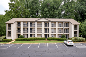 Spartanburg apartment for rent - an apartment building with a car parked in a parking lot
