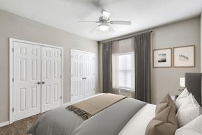 Austin apartment for rent - a bedroom with a ceiling fan and a window