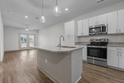 Raleigh apartment for rent - A kitchen with white cabinets and a granite countertop at Litchford 315 Apartments, North Carolina