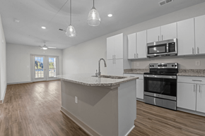 Raleigh apartment for rent - A kitchen with white cabinets and a granite countertop at Litchford 315 Apartments, North Carolina