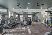 Raleigh apartment for rent - A gym with a variety of exercise equipment including treadmills, stationary bikes, and weight machines at Litchford 315 Apartments, Raleigh, NC