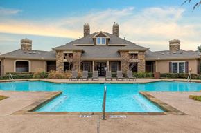 Arlington apartment for rent - Swimming pool with tanning deck and clubhouse exterior in the background