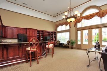 Greenville apartment for rent - A kitchen with red cabinets and a dining table with chairs.