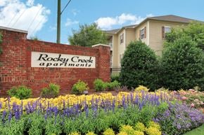 Greenville apartment for rent - Community sign in the middle of a flower bed.