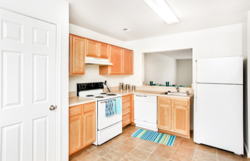 Fully-equipped kitchen with white appliances