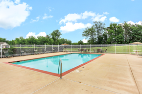 Fredericksburg apartment for rent - Pool area with outdoor seating. Pool lounge chairs and umbrellas in background