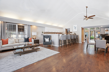 Gastonia apartment for rent - A living room with a white couch and a wooden floor.