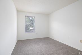 Kissimmee apartment for rent - A room with a carpeted floor and a window with blinds.