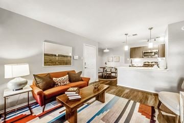 Carrollton apartment for rent - A living room with a red couch and a wooden coffee table.