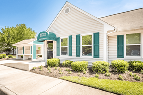 Newport News apartment for rent - a white building with green shutters and a green awning