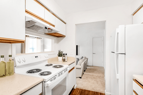 Newport News apartment for rent - a kitchen with a white stove top oven next to a white refrigerator