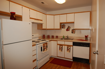 Huntersville apartment for rent - a kitchen with white appliances and white cabinets