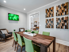 Plano apartment for rent - a dining room with a wooden table and green chairs