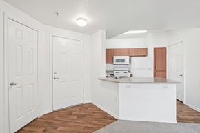 Peoria apartment for rent - A kitchen with white cabinets and a wooden floor.