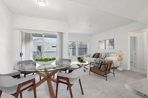 Peoria apartment for rent - A modern dining room with a glass table and chairs.