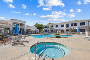 Peoria apartment for rent - Pool area with tanning chairs on the deck surrounded by natural landscaping