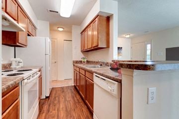 Waldorf apartment for rent - A kitchen with wooden cabinets and white appliances.