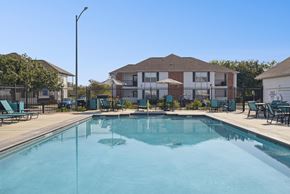 San Antonio apartment for rent - A swimming pool in front of a residential building.