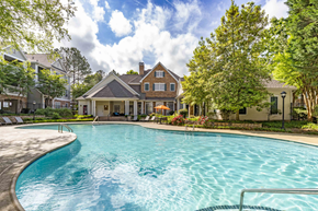 Charlotte apartment for rent - a large swimming pool with a house in the background