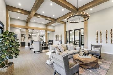 Taylorsville apartment for rent - A modern living room with a large grey sofa and a wooden coffee table.