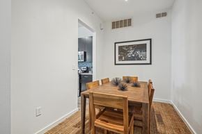Dallas apartment for rent - A dining room with a wooden table and chairs.
