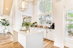 Tampa apartment for rent - a kitchen with large windows and a large white island