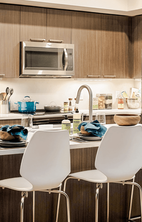 Denver apartment for rent - Two white chairs are placed in front of a kitchen counter.