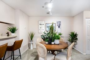 Douglasville apartment for rent - A dining room with a wooden table surrounded by chairs.