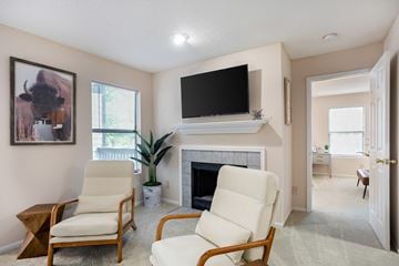 Douglasville apartment for rent - Two chairs are placed in front of a fireplace in a living room.