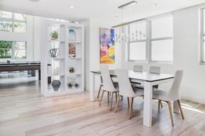 Miami apartment for rent - A dining room with a white table and chairs.