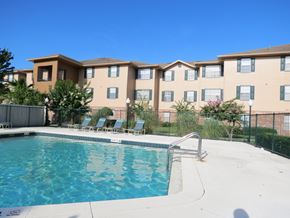 Orlando apartment for rent - A swimming pool in front of apartment buildings.