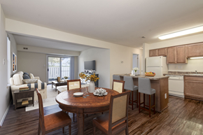 Waldorf apartment for rent - a kitchen and dining area with hardwood-style flooring and wood cabinetry