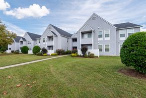 Waldorf apartment for rent - A row of houses with a green lawn in front.