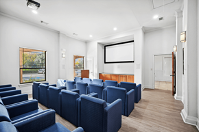 Dallas apartment for rent - a conference room with blue chairs and a projector