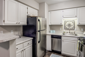 Hixson apartment for rent - a kitchen with white cabinets and stainless steel appliances
