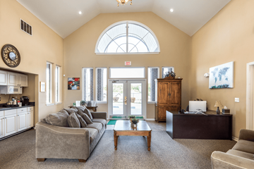 Kannapolis apartment for rent - A living room with a grey couch and a wooden coffee table.