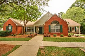 Huntersville apartment for rent - Club House Entrance with long sidewalk surrounded by trees