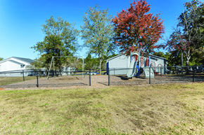 La Grange apartment for rent - A playground with a slide and a red tree in the background.